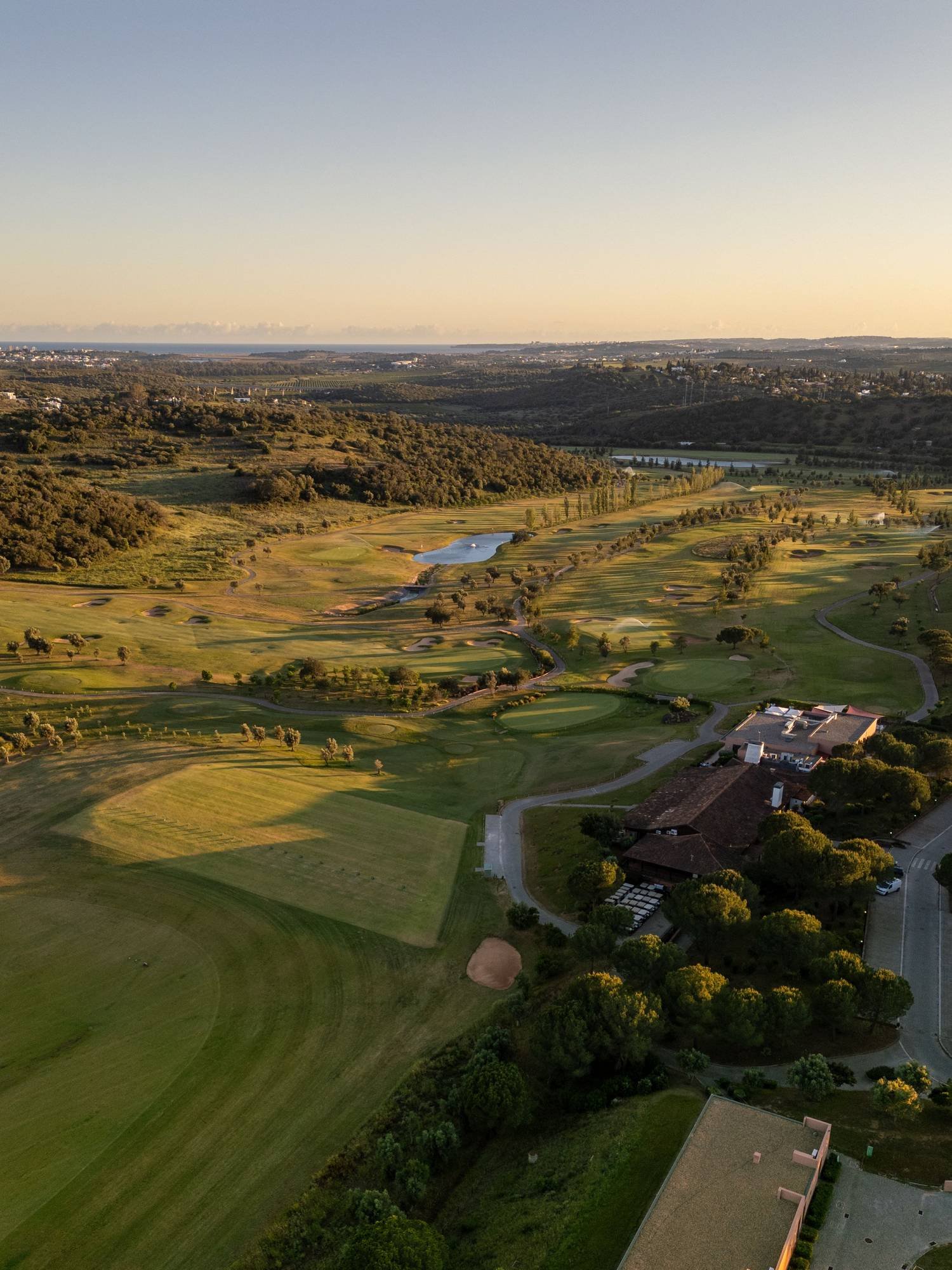 Aerial view of a golf course fairway at golden hour